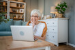 Senior caucasian woman use laptop computer at home for work