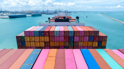 Stern of large cargo container ship import export container box on the ocean sea on blue sky back ground concept transportation logistic and service to customer and supply change..