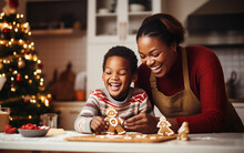 Black African American Dark-skinned Smiling Mother And Son Making Christmas Cookies At Home. Holidays And Celebration Concept