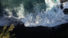 Turquoise Waves Crash White Onto Volcanic Black Sand Beach On Hawaii