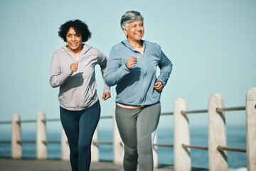 Canvas Print - Fitness, running and senior women at beach for health, wellness and exercise in nature together. Elderly, friends and ladies at sea happy, workout and active retirement, fun and bonding ocean run