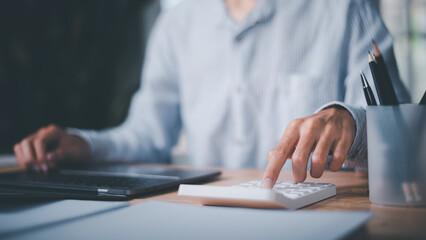 Aufkleber - Businessman using calculator to calculate numbers ,profit and loss statement review of company performance ,Cost analysis and calculation of financial documents ,business account checking