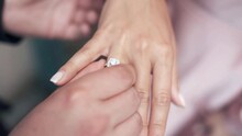Wedding Day. The Groom Places The Ring On The Bride's Hand. Diamond Engagement Ring