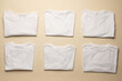 Close up of folded white t shirts and copy space on yellow background