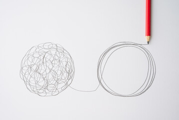 flat lay of pencil hand drawing line chaos to order circle on paper background. concept of abstract 
