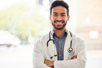 Sticker - Portrait, smile and asian man doctor with arms crossed in hospital with stethoscope for consulting on blurred background. Happy, face and male healthcare expert proud of clinic, service or help