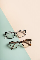 Wall Mural - Stylish eyeglasses on colored background. Optical store, vision test, stylish glasses concept.