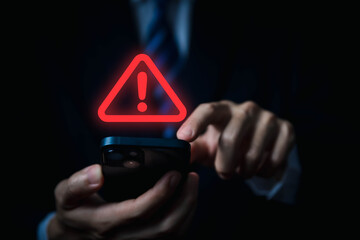 Wall Mural - businessman using laptop showing warning triangle and exclamation sign icon warning of dangerous pro