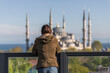 © Travel 'n' Lifestyle - View of a person looking at Sultanahmet Camii (the Blue Mosque) in Sultanahmet district along the Bosphorus strait, European side of Istanbul, Turkey.