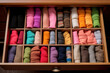 Neatly organized closet: colorful knitwear in drawer organizer