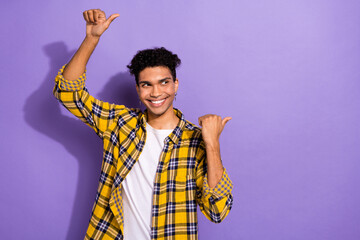 Poster - Portrait of good mood man with stylish earrings wear plaid shirt look directing at service empty space isolated on violet color background