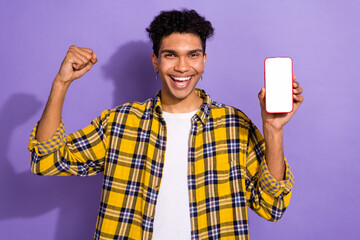 Wall Mural - Photo of funky lucky guy wear plaid shirt rising fist chatting instagram twitter telegram facebook empty space isolated violet color background