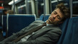 man asleep in train tired after hard work day