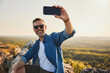 © baranq - Happy adult man taking selfie while hiking in Jura, Poland