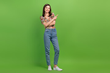Wall Mural - full body photo of cute gorgeous lady indicate finger empty space advert isolated on green color bac