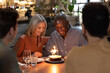 © ReeldealHD images - Senior couple celebrating a birthday with family in a restaurant