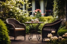 Wicker Chairs And A Metal Table In An Outdoor Summer Garden.