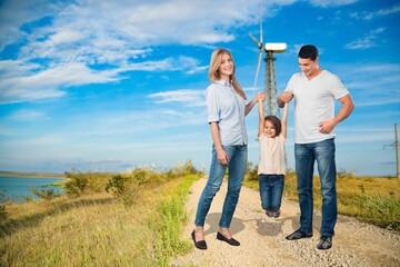 Wall Mural - Happy young family walking in the park.