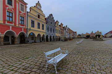 Canvas Print - Panoramic landscape of ancient market square with colorful renaissance buildings on in Telc, the Czech Republic. Cloudy summer morning. Iconic landmark of Telc. UNESCO World Heritage Site