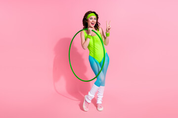 Wall Mural - Photo of excited sportive trainer lady hold hula hoop make v sign for sport blog followers body practice isolated pastel color background