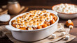 © Stock Love - Sweet potato casserole topped with marshmallows in baking dish on a table. Festive winter dish served for Thanksgiving Day family dinner. Mashed sweet potato. Oven baked sweet potato, autumn food