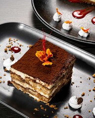 Poster - Delectable tiramisu with a flower artfully arranged on top