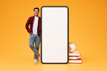 Poster - Cheerful Guy Leaning On Big Cellphone Screen On Orange Background