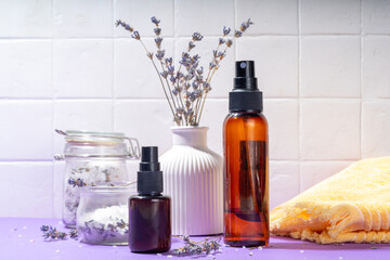 Cosmetics with lavender oil and dry lavender flowers. Aromatic essential oil, lavandula salt, spray, beauty care, wellness and natural beauty concept