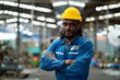 © KANGWANS - Expert african engineer Walking in industrial factory working with machines, factory black background