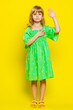 © Andrii Iemelianenko - I swear to be honest. Sincere responsible child girl kid raising hand to take oath, promising to be honest tell truth be polite, keeping hand on chest. Preteen children on yellow background. Vertical