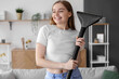 Young woman with vacuum cleaner at home