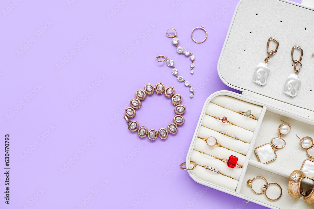 Organizer with stylish jewelry on lilac background