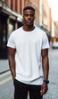 a vertical mockup of a male model wearing a white T-shirt