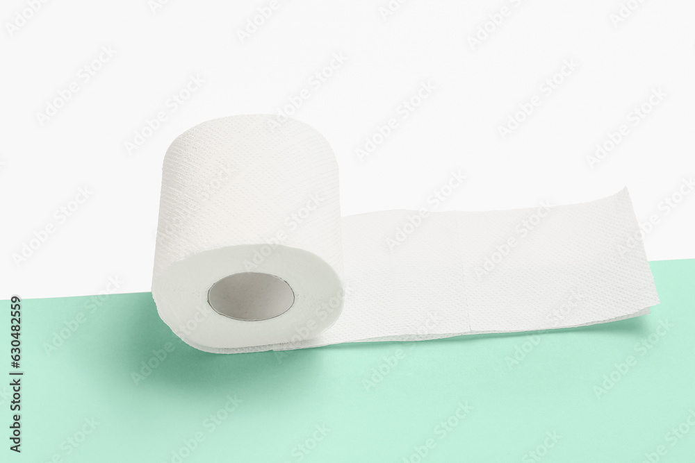 Roll of toilet paper on colorful background