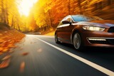 Fototapeta Niebo - car on the road in the autumn forest. speed motion blur effect