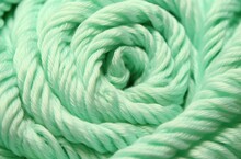 Close Up Of Green Knitting Yarn As A Background. Macro Texture.
