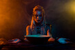 Portrait of viking druid woman interact otherworldly spirits demonic ritual orange light isolated on dark background