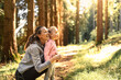 © kieferpix - Mother daughter bonding in autumn forest, enjoying nature and each other's company.