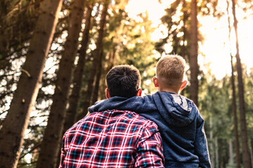 Father son enjoying nature forest setting. Family adventure exploring outdoors together 