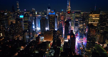 Wall Mural - Bright light on the street at the foot of skyscrapers. Never sleeping New York filled with lights from top.