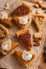 Wall Mural - Variety of Thanksgiving pie slices on parchment paper