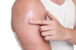 © New Africa - Man applying sun protection cream onto his shoulder against white background, closeup