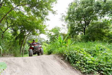 Wall Mural - man riding atv vehicle on off road track ,people outdoor sport activities theme.