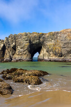 Arch In Sea Stacks Along Oregon Coast , Where Colonies Of Shore Birds Nest .