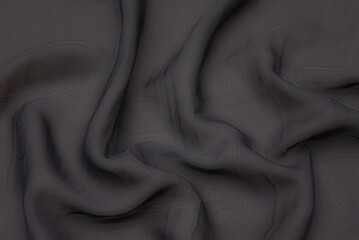 Wall Mural - Black fabric texture background, wavy fabric slippery black color, luxury satin or silk cloth texture.