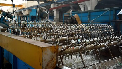 Wall Mural - Special rotating machines on a waste recycling factory working with plastic garbage. Slow motion