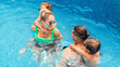 © frimufilms - Happy family in the pool