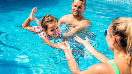 Happy family in the pool