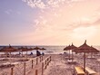 Sunrise over the sea on a beach full of straw umbrellas, Mahdia, Tunisia in Africa