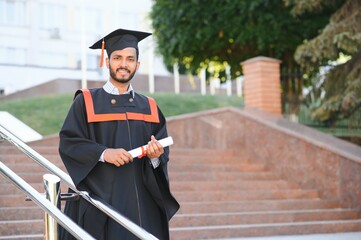 Poster - portrait of successful indian student in graduation gown.